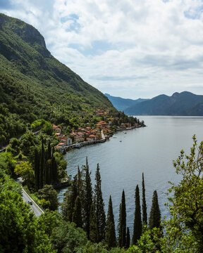 View of picturesque Varenna village by Lake Como with serene mountains and lush greenery, Lecco, Italy.