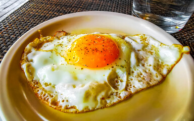Meal in the restaurant white plate with fried eggs.