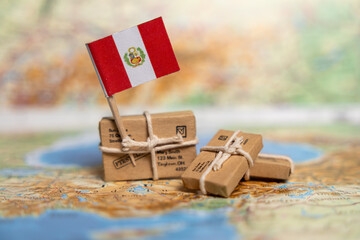 International Shipping and Delivery Services: Small Parcels with Peruvian Flag on World Map...