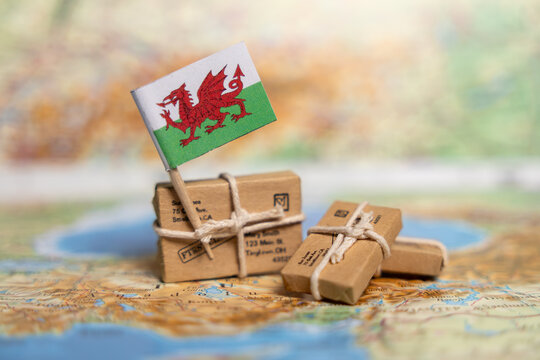 Global Shipping and Delivery Services to Wales: Small Business Parcels on Vintage Map with Welsh Dragon Flag
