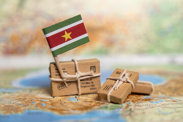 International Shipping and Delivery Services to Suriname: Small Packages on World Map with National Flag Shows Global Mail Transport