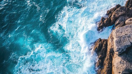 Obraz premium Close up aerial view of ocean waves crashing against rocky shorelines