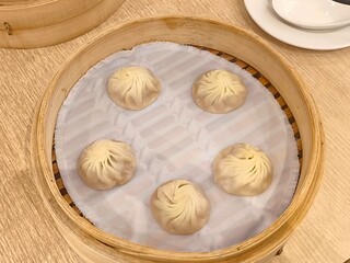 Xiao long bao in bamboo steaming basket. Steamed pork soup dumpling. Chinese steam bun. Chinese food menu