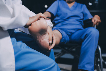 Physiotherapist nurse doing physiotherapy to rehabilitate leg of elderly female patient.