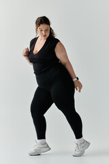 A stylish plus size woman expresses beauty and confidence in a contemporary indoor space.