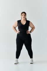 Obraz premium An elegant plus size woman stands confidently in fitted attire, showcasing her beauty and strength.