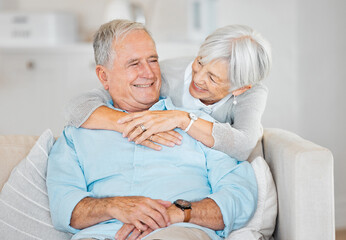Home , senior couple and happy with hugging on sofa in living room for bonding, support and retirement. People, relationship and smile at apartment of couch as pensioners with love, care and relax