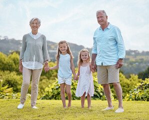 Fototapeta premium Nature, holding hands and portrait of children with grandparents for bonding, walking and relax together. Family, happy and grandpa, grandma and girls outdoors for playing, vacation and holiday