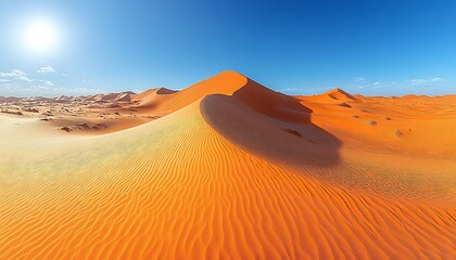 Expansive desert landscape with vibrant orange dunes under a blue sky.