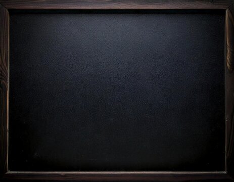 Vintage school blackboard on the dark textured grunge wall background. Blank chalkboard in the wooden frame education learning mockup.	