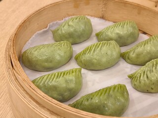 Steamed shrimp and pork dumplings in bamboo steaming basket. Steamed pork jiaozi. Chinese steam bun. Chinese food menu