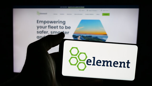 Stuttgart, Germany - 10-28-2024: Person holding smartphone with logo of Canadian company Element Fleet Management Corp. on screen in front of website. Focus on phone display.