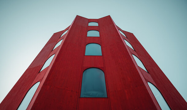 Looking up at the Juliertheater building. Wide angle image of bright red star-shaped tower - view from a close distance. Julier pass, Switzerland - September 21 2019. 