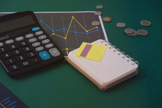 Open leather notebook, drawings, charts, phone, calculator, pencil and laptop on the desk in the office. Business and Finance. - Powered by Adobe