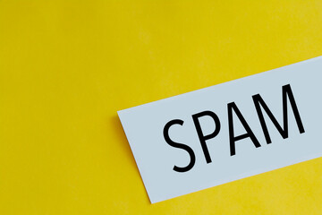 note paper with the word "spam" on a yellow background with space for copying