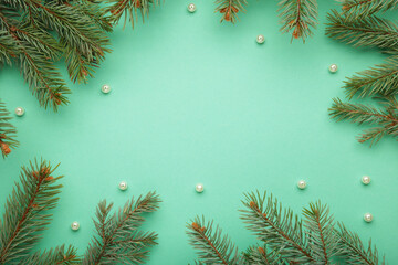 Christmas minimal concept - Christmas composition with fir branch and white bauble on mint...