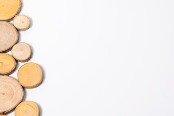 Wooden carved texture on white background, close-up of a piece of wood, wooden pieces of different diameters with a crack on white background, natural products
