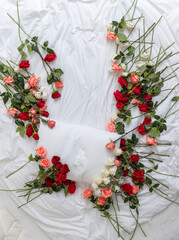 Overhead view of  a bed Surrounded by Roses and Valentine's Day Decorations