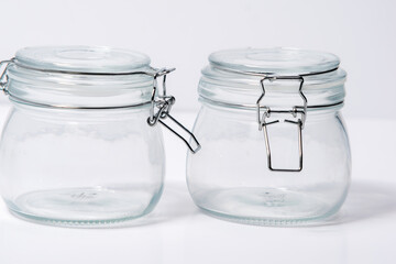 Empty glass jars placed on white background, two empty glass jars,