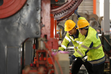 Industrial man engineer wear uniform working and checking system machine at factory. Workers...
