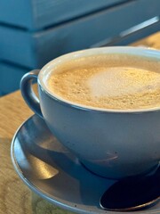 grey cup with cappuccino and foam