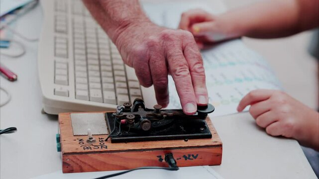 A man and a woman using a telegraph device with a decipher morse