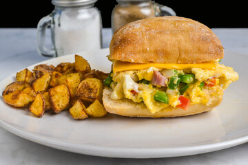 scramble egg with peppers onions and ham  on ciabatta roll