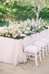 A beautifully decorated outdoor table with fresh flowers, ideal for garden parties, weddings, and elegant gatherings.