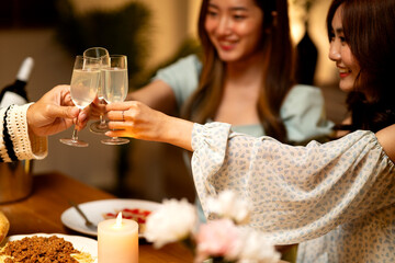 group of friends raise a glass of champagne celebrated in a fun party