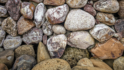 Various shades of river stones, Texture background, River floor pattern.