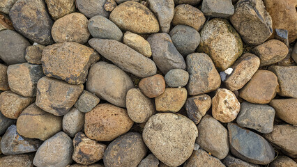 Various shades of river stones, Texture background, River floor pattern.