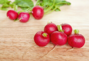 Eight radishes on wood.