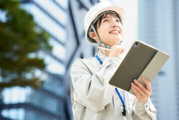 作業服とヘルメットを着用した若い女性