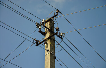 power line pole with wires on blue sky background. electricity transmission concept