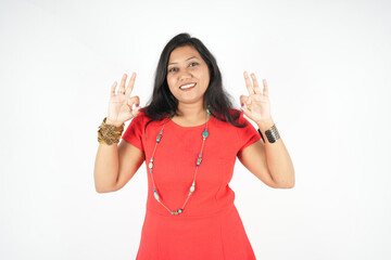 Attractive smiling young woman looking at the camera showing OK sign feeling happy isolated over white background stock photo