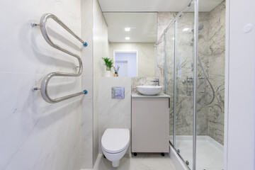 Bright Elegant Modern Luxury Home Bathroom Interior Design With White Sink. Marble Gray Walls, Mirror and Faucet. LED Lights. Shower Area, Heater, Tile Floor and Walls