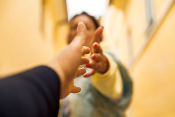 Reaching hands in motion - symbolizing connection and support in a vibrant urban setting