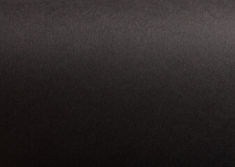 Elegant black background with a subtle, textured effect, accented by soft light, creating a premium,