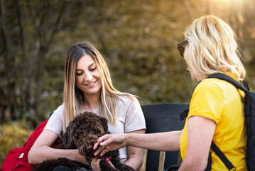 Park, smile and two woman with dog in park, playing and training outdoors together. Friendship,...