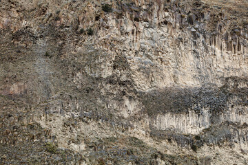 landscape, natural texture - sheer mountain cliff with cracks and vegetation