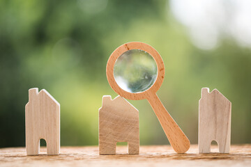 Many home model and magnifying glass put on the old wood on bokeh background, Loan for real estate...