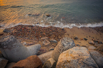 stones on the shore of the Baltic Sea after sunset
