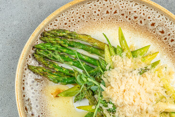 Asparagus salad with cheese on plate. Long banner format. top view