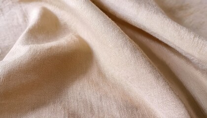 Close-up of soft beige fabric, ideal for backgrounds and textile designs, highlighting texture and elegance.