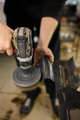 Automotive Maintenance Expertly Polishing Car Parts in the Workshop for a Gleaming Finish