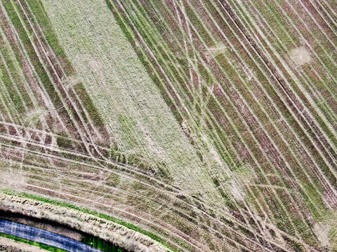 aerial view of arable lowland agricultural field with intersting patterns of plough marks