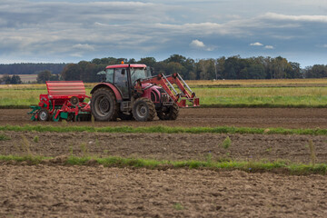 Farmer in tractor seeding soybeans at industrial agricultural farm