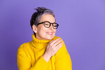 Photo portrait of lovely pensioner lady hugging touch shoulder dressed stylish yellow garment isolated on violet color background