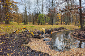 dredger for cleaning reservoirs in autumn park