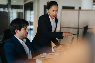 Female entrepreneur explaining ideas to male colleague while working in office